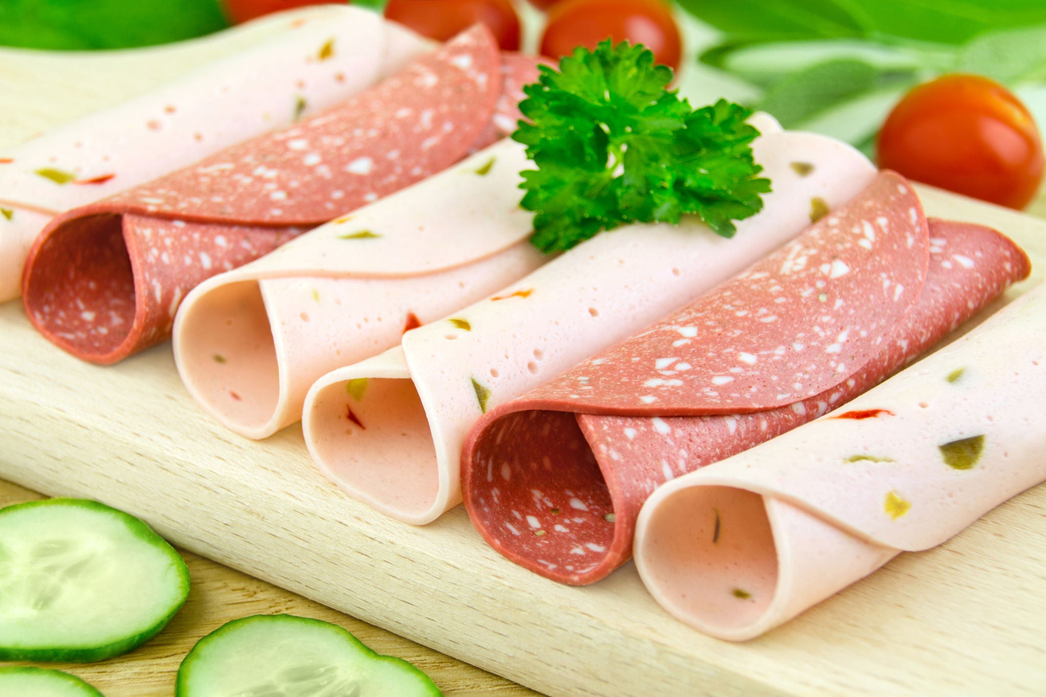 Deli Meat Slices on Wooden Board with Fresh Garnish