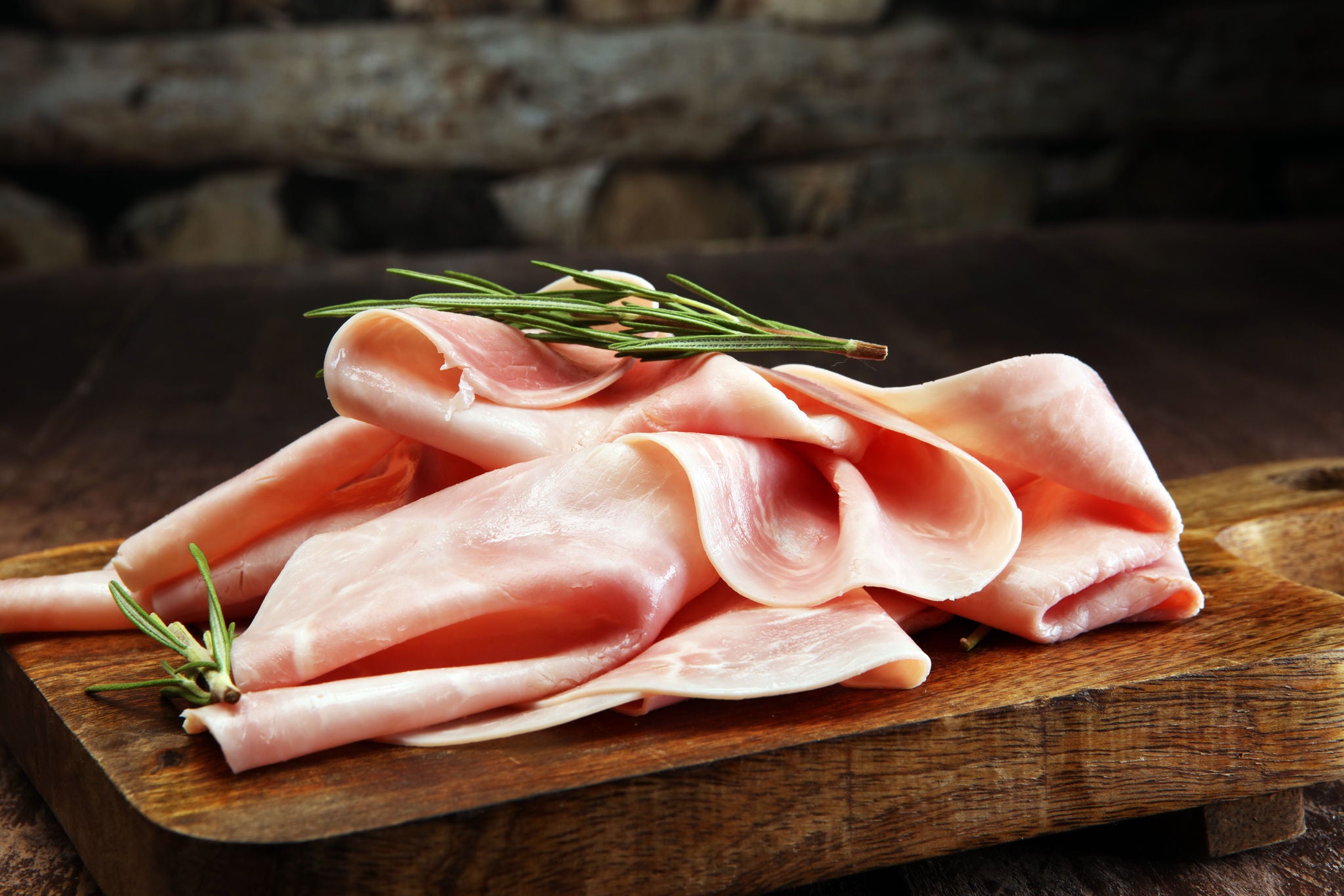 Ham Slices with Rosemary on Wooden Board