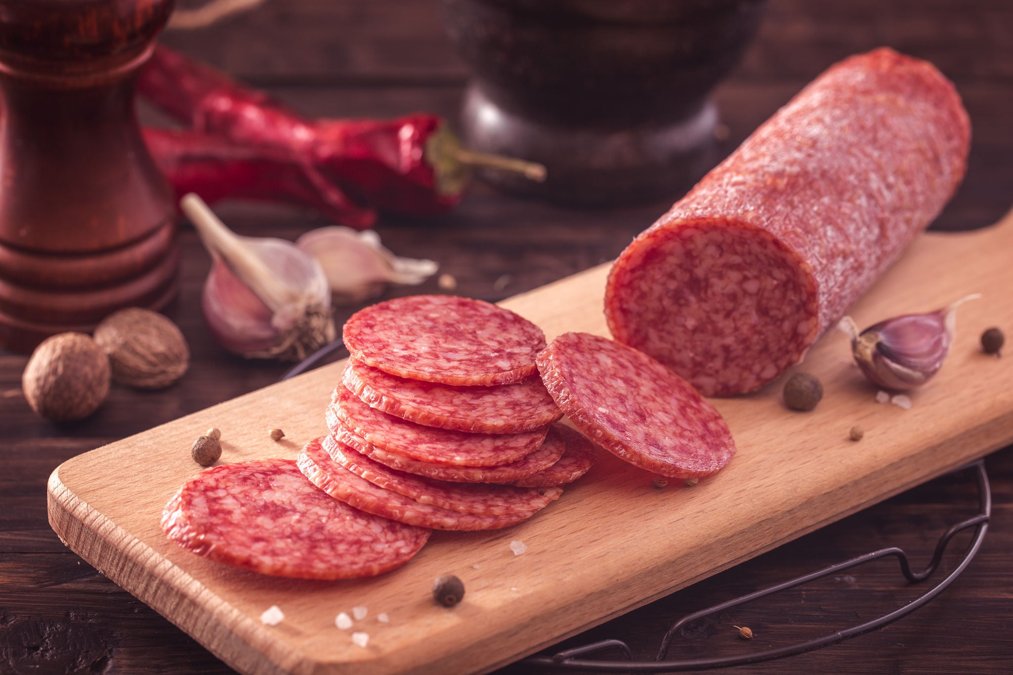 Salami Slices on Wooden Board with Spices