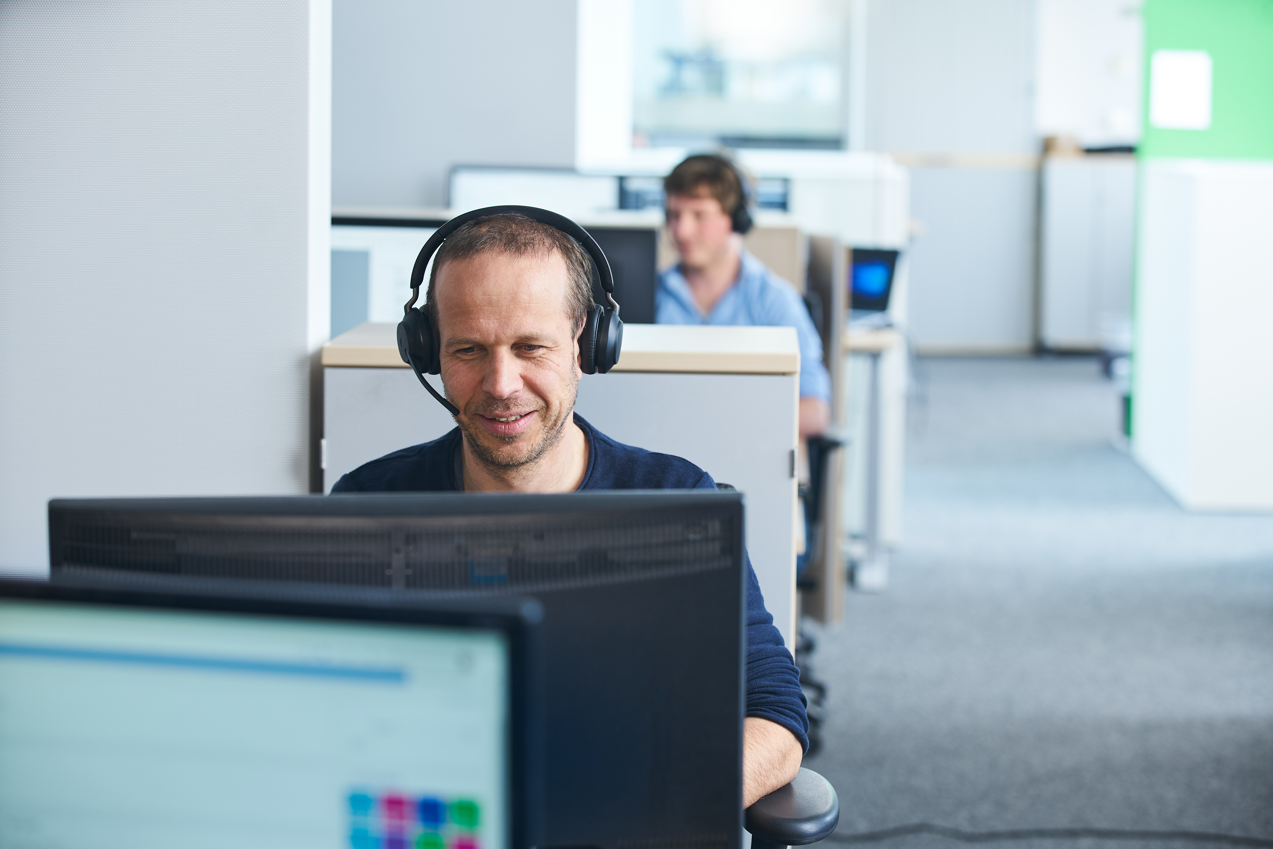 Office Workspace with Computers and Headphones