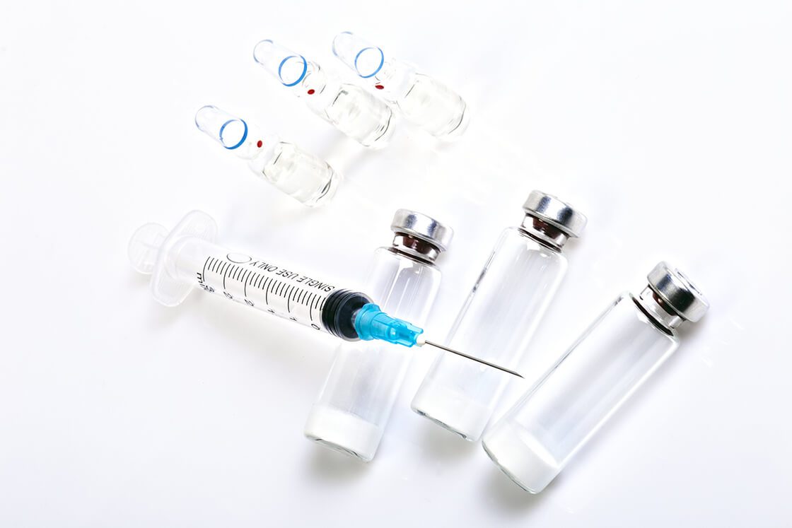 Medical Syringe and Vials on White Background Medical Syringe and Vials on White Background