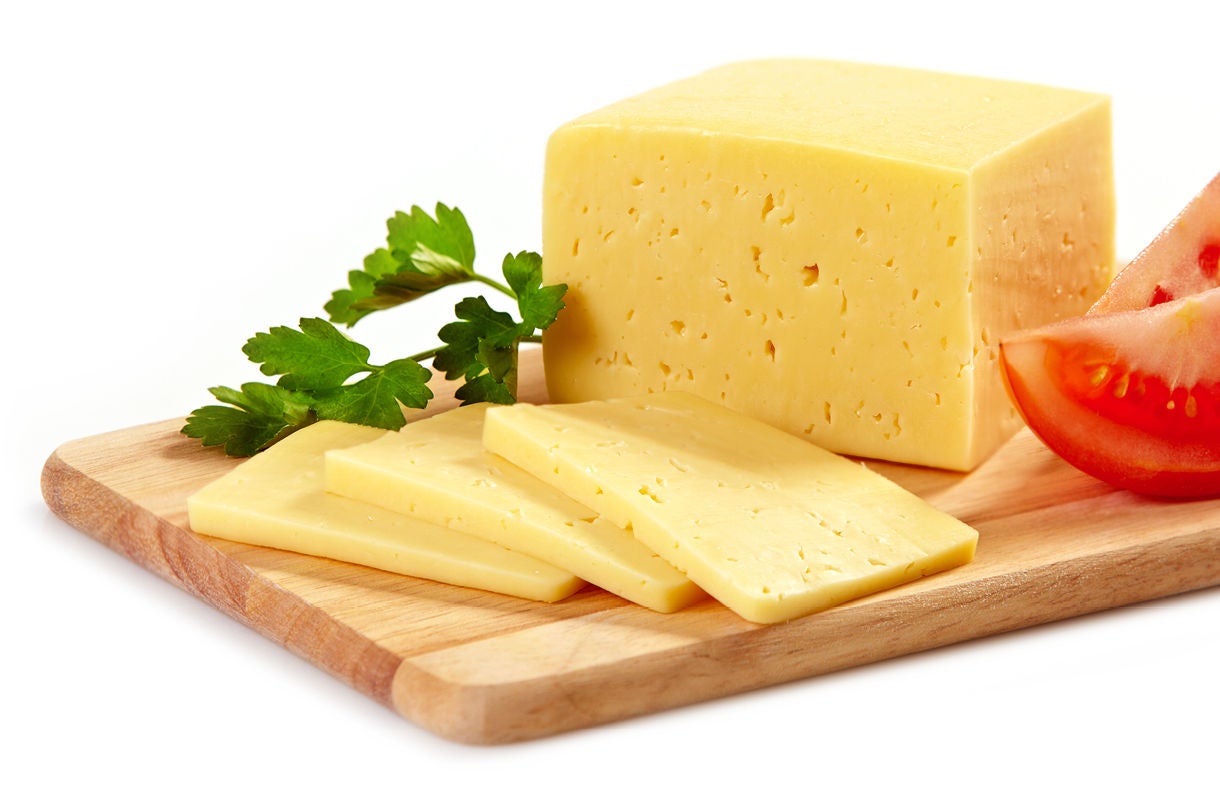 Cheese Slices with Tomato and Parsley on Wooden Board Cheese Slices with Tomato and Parsley on Wooden Board