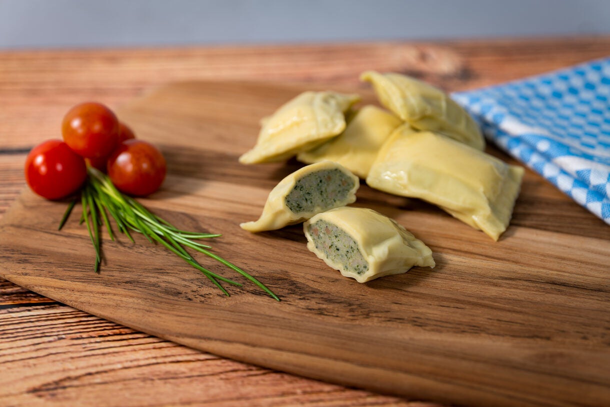 Ravioli on Wooden Board with Cherry Tomatoes Ravioli on Wooden Board with Cherry Tomatoes